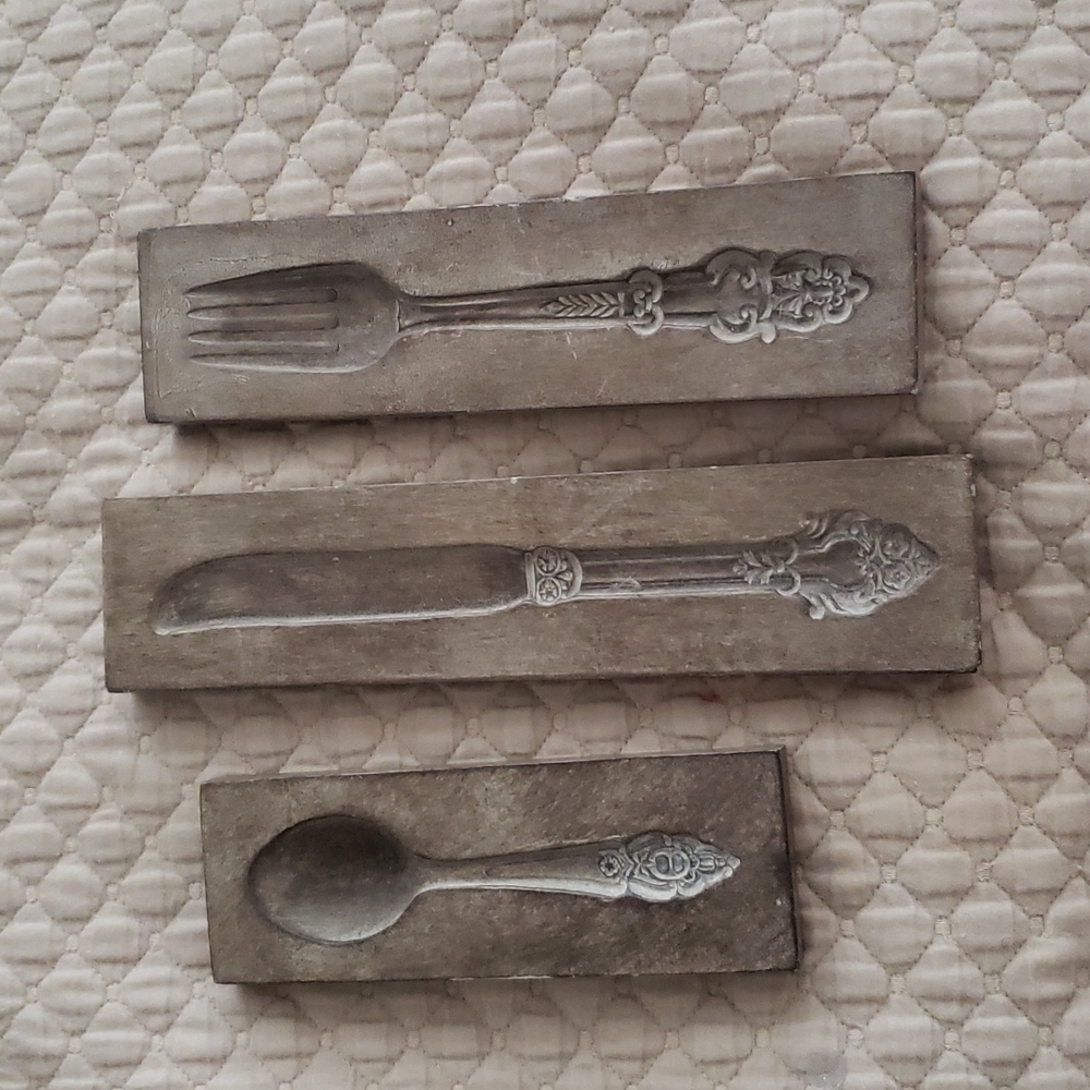 Replica period pieces of Victorian silverware...wall decor.